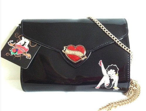 Black Betty Boop Heartbreaker clutch bag is a black colour clutch bag with Betty step out pose on one side. It has stylish Betty red and gold metal heart clasp with magnetic closure.  Exclusively Available at Reliance Gifts www.reliancegifts.co.uk