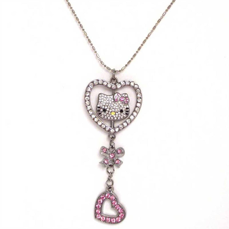 Sparkling Kitty Necklace is a silver colour chain with pendant. The pendant has one hello kitty head charm inside a heart studded with clear Austrian crystal with a pink bow and pink heart dangler at the bottom .Exclusively Available at Reliance Gifts www.reliancegifts.co.uk